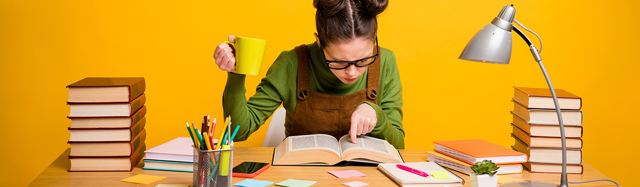 A person looking up terms in a book